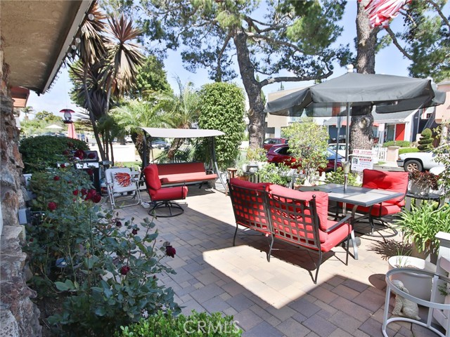 The beautiful front patio who brick flooring and vinyl picket fence.  The perfect place to enjoy the nice beach weather.