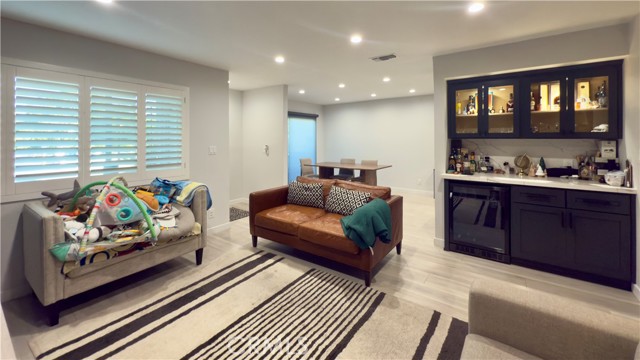 Living Room with custom built bar & mini fridge