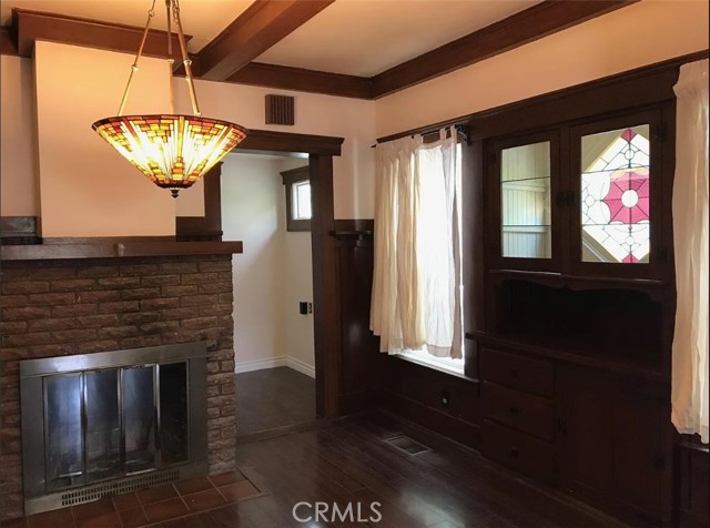 Dining room with vintage chandelier and built-in, window backlit buffet.