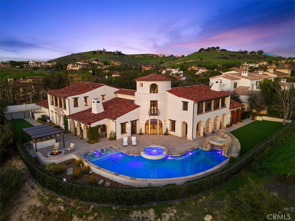 This is your chance to own a piece of paradise. Behind the guard gated entry of Shady Canyon lies this exclusive estate on half an acre. This Irvine view home features 5 ensuite bedrooms, 6 full bathrooms, 2 half baths, and 2 offices, this 9,239 sqft sprawling estate with a main floor master is perfect for those who demand the best in life. Recently remodeled, the pool features a baja step, custom rock slide grotto and waterfall along with a jacuzzi. The private cul-de-sac location offers unobstructed views of Boomer Canyon. The basement is home to a movie theater, wet bar, full bathroom, a meditation room and space for a home gym, wine cellar or kids playroom. The main level consists of a gourmet kitchen with walk-in pantry & top of the line appliances that is open to the family room. A formal dining room, living room, master retreat with sitting area and dual walk-in closets along with an office, and laundry room make up the main floor. The second floor has 4 bedrooms that each have a walk-in closet and access to one of the two balconies. The third level is a dedicated office space with built-ins and breathtaking views. The 4 car garage and gated driveway is perfect for any car aficionado. Close to award winning Irvine Schools, Orange County beaches, and John Wayne Airport. Shady Canyon Golf Club as well as tennis and swim centers are available to Shady Canyon residents. Don't miss your chance to own this luxurious estate in paradise!