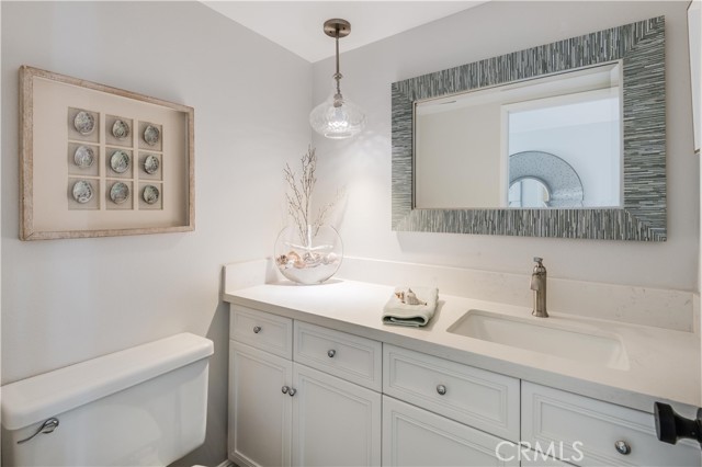 Powder room with new quartz counter, new sink, new faucet and light fixture. Powder room with new quartz counter, new sink, new faucet and light fixture.