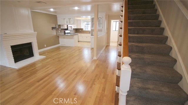 Living/dining area and stairs leading to bedrooms