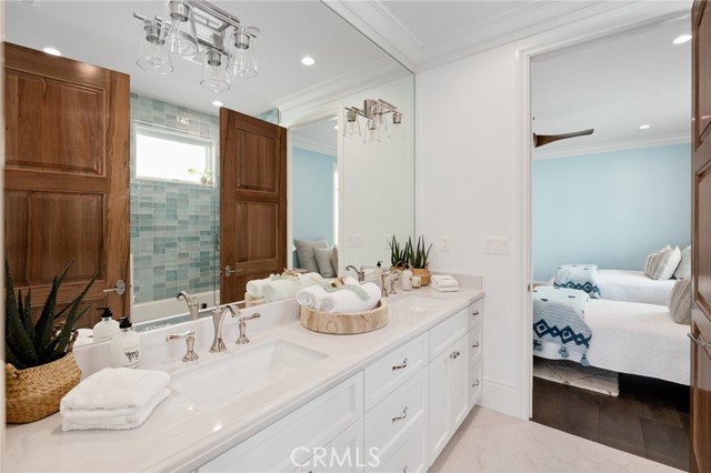 Jack and Jill Bath with Dual Vanities and Alder Wood Doors