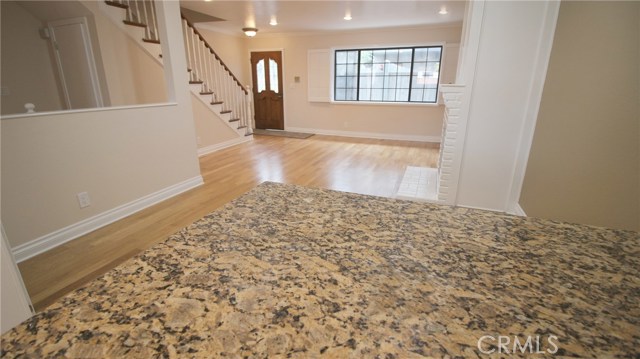 View of living room and front door from kitchen