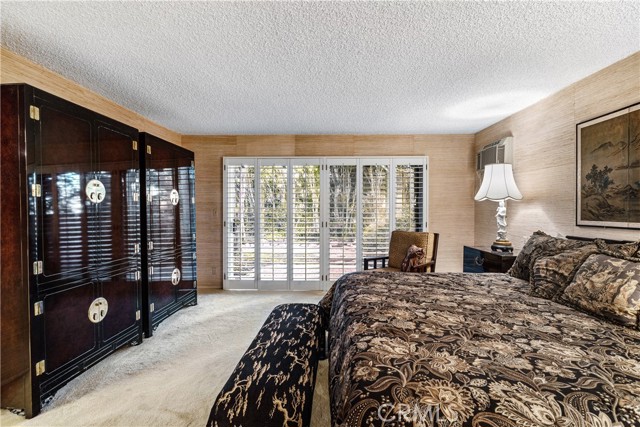 The main bedroom is a large suite with gorgeous views to the beautiful tree and greenery in the backyard garden.