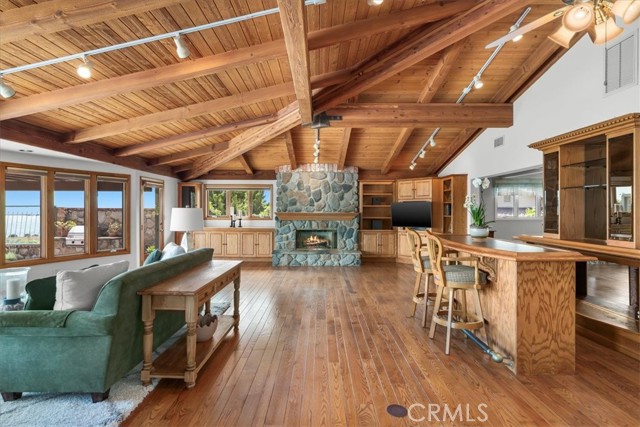 Living Room featuring expansive windows, providing abundant, natural light, along with sunrise and ocean views.