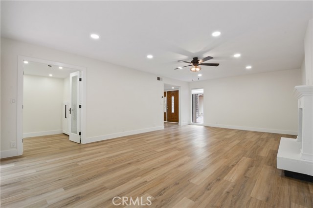Spacious living room with recently remodeled fireplace, newer laminate flooring and new verticle blinds.