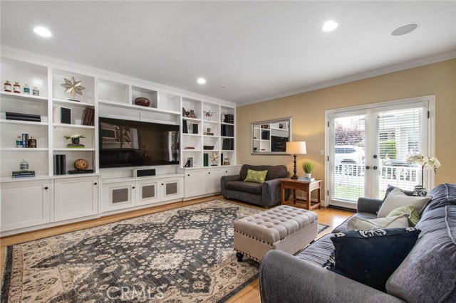 Bonus/media room first floor with French doors going to grassy yard out front.
