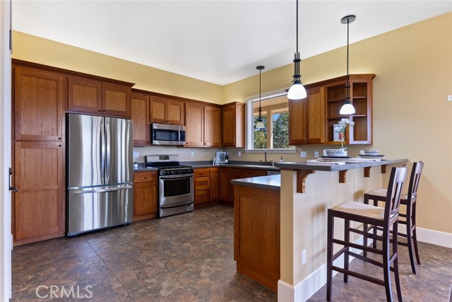 Custom soft close cherry wood cabinets, SS appliances and wine fridge. Easy access to basement.