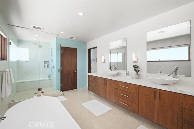 Primary bath with custom sinks fixtures and stonne