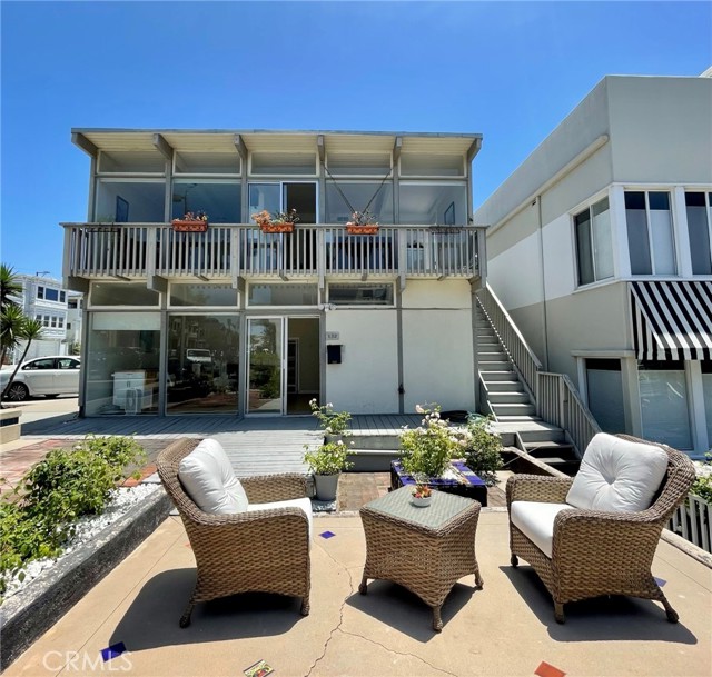 Front view of home and deck area.  Faces walkstreet.