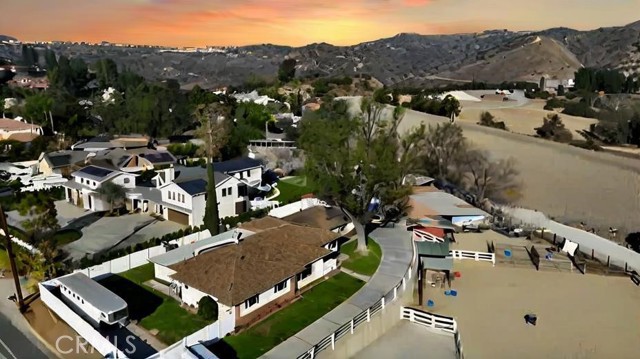 Welcome to 7741 E Santiago Canyon Rd, Orange, where rustic charm meets equestrian elegance on nearly an acre of pristine land! This sprawling 4-bedroom, 2-bathroom ranch-style home, spanning 2,700 square feet, sits on a 46,491 sqft lot, making it an ideal haven for horse enthusiasts and those seeking a peaceful retreat. The main house exudes warmth with a traditional brick exterior and expansive windows inviting natural light and views of the scenic landscape. Equipped with a professionally designed riding arena, tack room, and stalls that accommodate up to 16 horses, this property is truly a dream for equestrian lovers. There’s ample space for riding, training, and enjoying the outdoors with two separate garages, perfect for parking and storage needs. Additionally, a refreshing pool complements the backyard, offering a perfect spot to relax and entertain under the California sun. Whether you’re looking to indulge in a passion for horses or simply savor the serene environment, 7741 E Santiago Canyon Rd combines functionality, comfort, and charm for a one-of-a-kind lifestyle. Make this your private sanctuary close to the city but steeped in countryside tranquility.