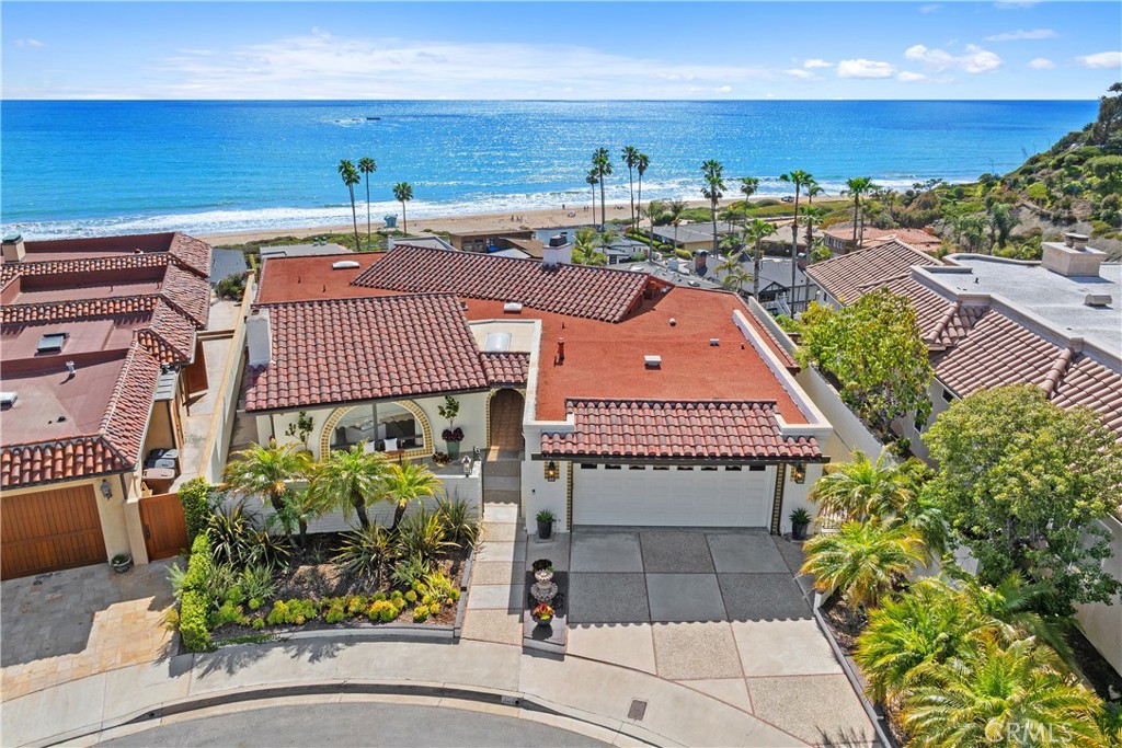 First time on the market! Tucked away on a small private culdesac in the prestigious and highly sought-after Riviera District, this single-level Spanish-style home offers breathtaking ocean views and an exceptional coastal lifestyle. Featuring 3 bedrooms, 2 bathrooms, and approx 2,643 sf of living space, the home is situated on one of the premier elevated lots in the community—perched perfectly to capture sweeping, unobstructed views of the Pacific. A charming front gated courtyard welcomes you into a residence filled with character and timeless style. The kitchen is a chef’s delight w/stainless steel appliances, granite counters, light-toned cabinetry, center island, walk-in pantry, and a cozy breakfast nook with stunning ocean views. The formal dining room flows into a spacious living area, both anchored by a dramatic two-sided fireplace & elegant stone wall feature. Full-length windows frame panoramic ocean vistas, while wood-beamed ceilings add architectural charm. The primary suite is a true retreat w/large windows & sliding door opening to the deck, offering captivating ocean views and abundant natural light. A skylight adds even more sunshine, while dual closets, a makeup vanity w/large mirror, dual sinks w/granite countertops, and a walk-in shower complete the space. The secondary bedrooms are generously sized, offering flexibility for guests, home office, or additional living space. The back bedroom features vaulted wood ceilings with exposed beams, a decorative fireplace, and a unique oval window—making it an ideal bedroom or bonus room. Additional features include an attached two-car garage w/epoxy flooring & built-in storage, a mud room w/sink, plantation shutters throughout, ceiling fans, recessed lighting, and multiple skylights that flood the home with light. The expansive multi-tiered deck wraps around the entire back of the home and is one of the best vantage points in the community. With multiple levels designed for both entertaining and relaxing, it offers an unmatched setting to enjoy coastal sunsets, ocean breezes, and sweeping views stretching across the Pacific. Located in one of San Clemente’s most exclusive enclaves, the Riviera District is beloved for its direct beach access, proximity to the scenic San Clemente Beach Trail, and its quiet, family-friendly streets. San Clemente itself is known for its world-famous beaches, historic charm, and vibrant Avenida Del Mar—lined with boutique shops, cafés, and restaurants.
