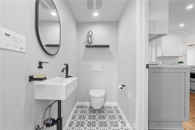 Bathroom #3 is a beautifully designed 1/2 bath, and a convenient powder room to the living spaces.