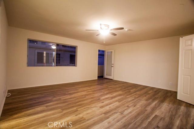 Large master bedroom is on middle level with balcony, new wood flooring, new lighting.