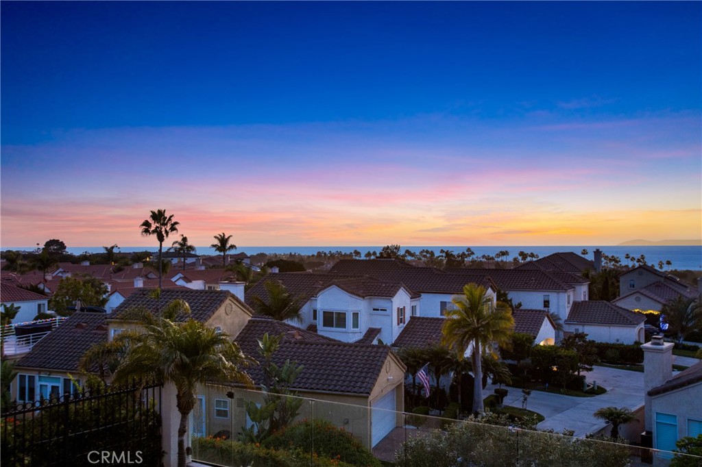 Located in the prestigious, gate-guarded community of Monarch Beach, this exquisite 3-bedroom, 2.5-bath home offers 1,890 square feet of beautifully updated living space. As you step inside, you’ll be greeted by breathtaking panoramic views that set the tone for this coastal retreat. The kitchen boasts a gas stove in the island with a stainless-steel hooded vent above the island, double wall ovens, and stainless steel appliances making this kitchen a chefs dream The home has been thoughtfully upgraded with all-new flooring and freshly painted baseboards, creating a clean, modern ambiance throughout. A brand-new HVAC system with an EcoB smart thermostat and an energy-efficient Slim Line AC ensure comfort and sustainability. The fully paid-off Tesla Solar System and Tesla charging station are perfect for eco-conscious homeowners, offering both convenience and cost savings. Elegant new plantation shutters adorn the windows, adding timeless charm, while fully approved and permitted plans for a remodel, including a stunning new wrap-around deck, open the door to future enhancements. The backyard is spectacular, providing a private oasis ideal for gatherings and soaking up the California sun. Location, location, location! This home is directly across the street from the luxurious 5-star Waldorf Hotel with fine dining, a championship golf course. You will be less than a mile from the pristine white sands of Salt Creek Beach and the Ritz Carlton. If you seeking the finest of coastal living, look no further. Call us today to view this extraordinary property.