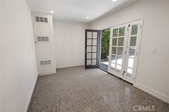 Interior of the garage which functions as a flex space or office. French Doors to the back Patio.