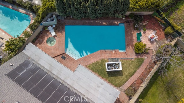 Entertainers dream backyard with custom brick work, deep swimming pool, and jacuzzi.