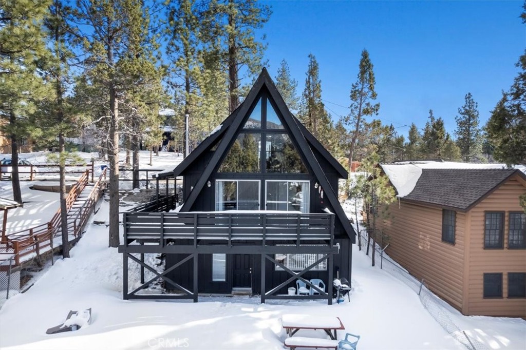113 E Fairway Boulevard Big Bear City, California Welcome to 113 E Fairway, an impeccably re-designed A-frame cabin in the mountain town of Big Bear. This freshly painted home features an open floor plan with a wrap-around patio looking over the large backyard. Inside you’ll find large windows allowing natural light to fill the space. The brand new fireplace and high ceiling create a cozy yet elegant living room with plenty of space to host your family and friends. Upstairs a loft over-looks the living room and leads back into the third bedroom and second bathroom. On the ground level of the home, you’ll find a remodeled kitchen and a dining space with lots of bright light and a door leading to a covered patio and the backyard beyond. This property makes for the perfect first home, a weekend getaway for your family and friends, or an excellent short-term rental investment property! This home comes FULLY FURNISHED and ready for its’ new owner! UPGRADES INCLUDE: Full exterior paint, Repaired the entire deck and replaced all broken pieces of wood, deck rails fixed to code, converted fire place to electric, new floors on bathrooms and laundry, added railing to indoor staircase, insulated pipes underneath the house, new kitchen cabinets, counter tops, range hood, paint on the walls, and ceiling, pipe insulation, new water and gas lines, and added new lights in the kitchen.