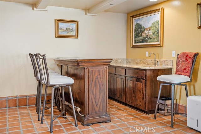 In the corner of the room is a built in wet bar with sink!  The bar in front is moveable and stays with the home.