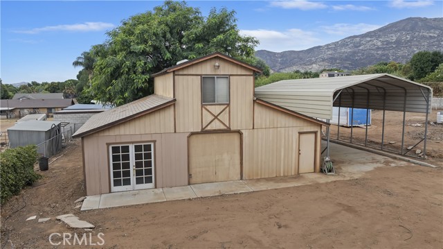 View of barn with hills behind
