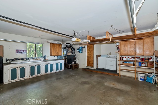 Huge garage with cabinets and a 220 receptacle