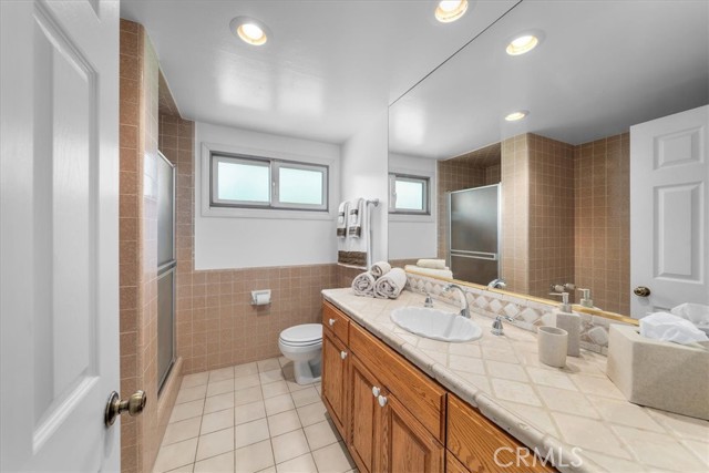 Bathroom #2 with step in shower and bathtub.