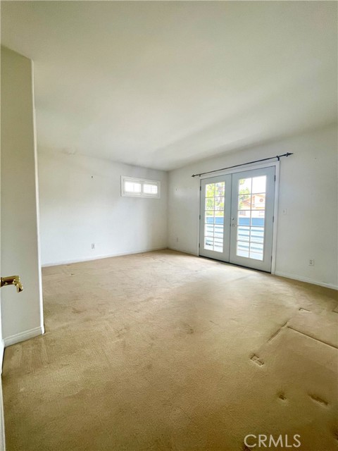 Second Primary Bedroom/Den/Family room with French doors off to balcony