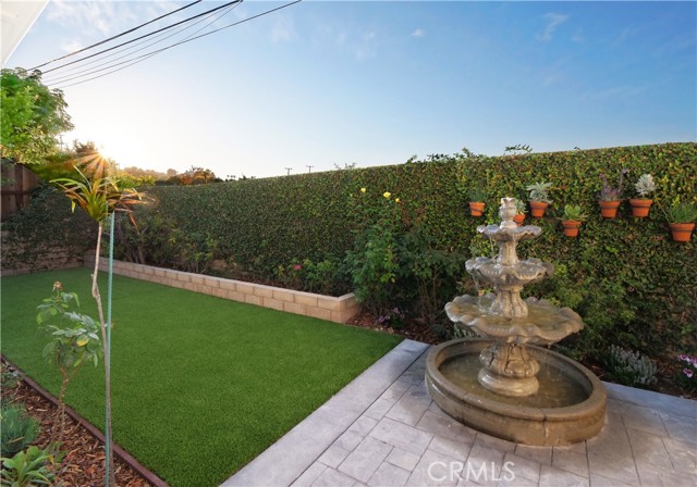 Backyard with sculpted fountain and new turf