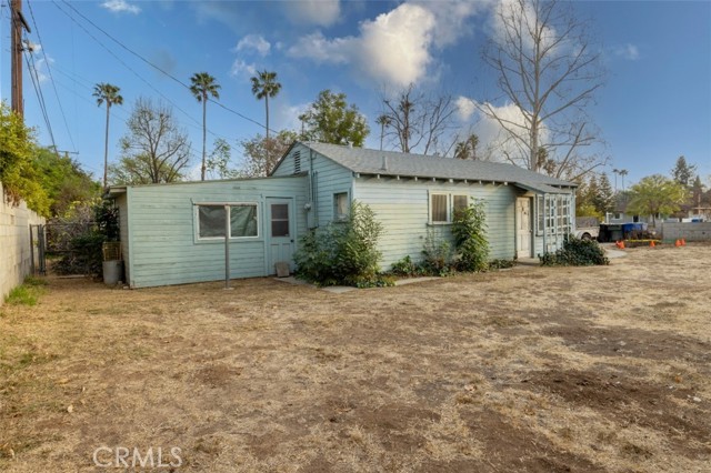 Side view of home with added shed/room off the back (unsure of permits -- buyer to do due diligence).