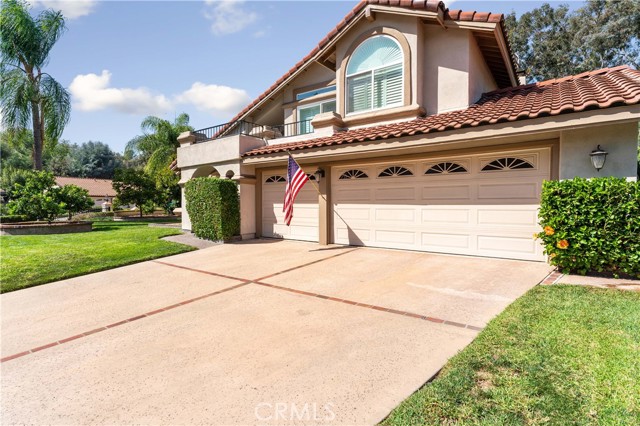 Beautiful home with pride of ownership. Balcony from Primary bedroom, three car garage and space to park three in the driveway. Tile roof.Citrus tree in front. Hibiscus plants by garage.