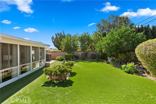 Backyard - The fully fenced-in backyard provides lushness with its mature landscaping.