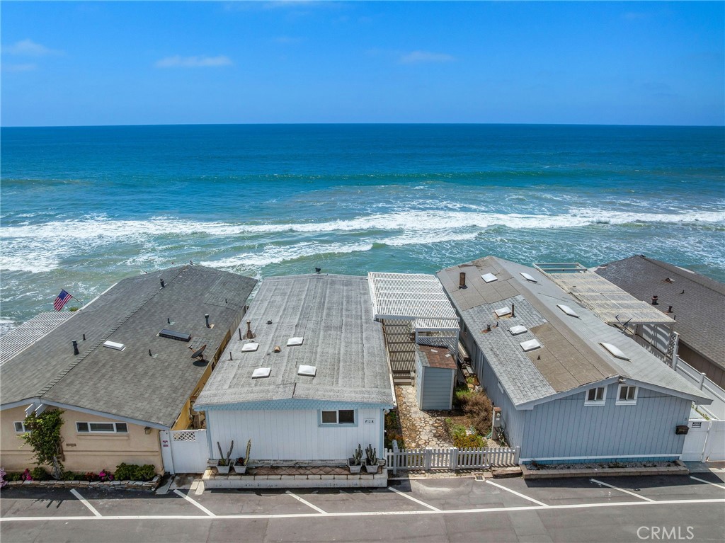 Unobstructed on-the-beach views extending from San Clemente’s famous pier to the towering Dana Point Headlands set the scene for outstanding oceanfront living at this classic home in the private community of Capistrano Shores. A sunny patio introduces the single-level residence, which welcomes abundant natural light and breathtaking whitewater, Catalina Island and sunset views through massive floor-to-ceiling windows in the living room. Approximately 1,000 square feet, the open-concept design makes it easy to entertain by erasing boundaries between the kitchen, living and dining rooms. A peninsula bar for serving up appetizers and enjoying morning coffee opens to the living room from the kitchen, where white Shaker cabinetry, low-maintenance contemporary countertops, a Bosch dishwasher, and a range with smooth cooktop are on display. Two bedrooms and two baths lend versatility to the home, which is also appointed with high ceilings and woodgrain laminate flooring. Nearly 2,265 square feet, the homesite reveals a beach-front patio with retractable awning and a coveted location within Capistrano Shores. One of San Clemente’s most sought-after addresses, the seaside enclave is moments from miles of beach trails, shops and restaurants along Avenida del Mar, Dana Point’s beautifully revitalized harbor, famous surf spots, scenic neighborhood parks and the Ole Hanson Swim Club.