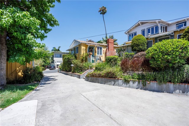 231 Cajon Street Laguna Beach, California Your own private compound located just 2 blocks from the beach in prestigious North Laguna! Four cottages plus a carriage house (5 units total), and a 4-car garage, on 2 legal lots totaling 9,000 square feet. The 4 stand-alone bungalows are independent, each with about 470 square feet including one bedroom, a full bath, vaulted beamed ceilings, wood floors, fireplace and a full kitchen. In addition, there is a 2-bedroom carriage house above the garage featuring ocean views and a large deck. Altogether this property comprises 6 bedrooms, 5 bathrooms, 5 full kitchens, 5 living rooms, 4 fireplaces, the 4-car garage, a laundry room and a workshop. There is additional parking in the driveway and off the alley in the back. The lot is street-to-alley, and would support either one or two single family homes, or up to 5 multi-family units as it is currently configured. Live in one unit and collect income from the others, or connect them, or use them as detached studios, offices or guest rooms. Garage access could be easily moved to the alley, enabling the open space of the lot to be fully utilized: there is plenty of room for a spa, fire pit, bocce court... The possibilities are endless! All this just moments from Crescent Bay and Shaws Cove, plus all the shops and restaurants of North Laguna! The property currently generates over $11,500 in monthly income, all tenants have been long term and are currently on month-to-month leases.