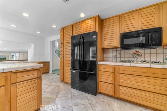 Kitchen with tile floors, remodeled cabinets and recessed lighting