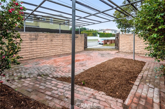 This was a gardening area. Drape a mesh  screen over the top, add a gardening table below