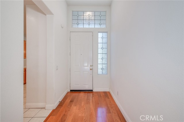 Entry with stunning floors and leaded glass like windows at side and over front door.