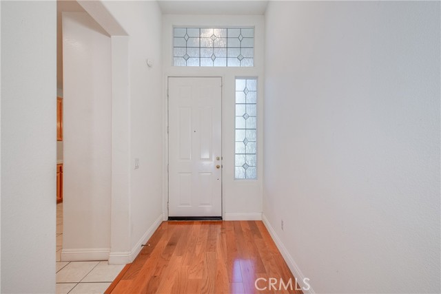 Entry with stunning floors and leaded glass like windows at side and over front door.