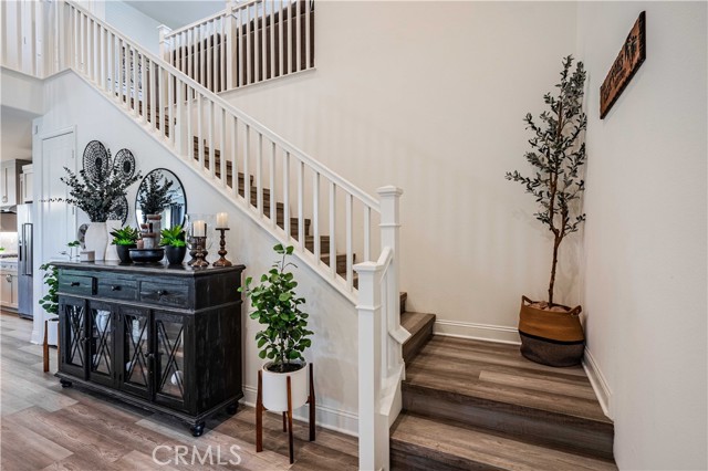 Gorgeous stairway is wood laminate trimmed in white stairway railings leads to your loft, 4 bedrooms and 3 more full bathrooms.