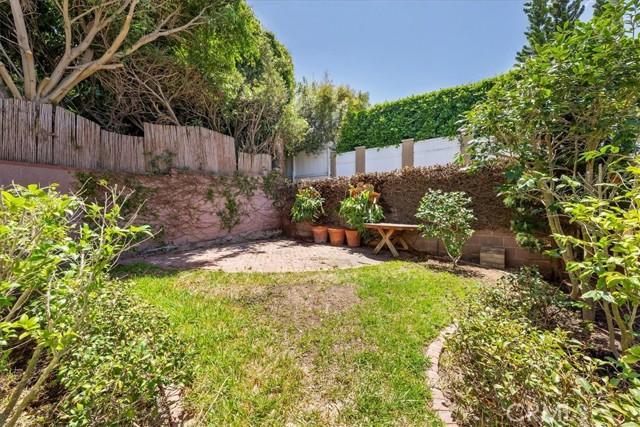 Backyard with alley behind back fence.