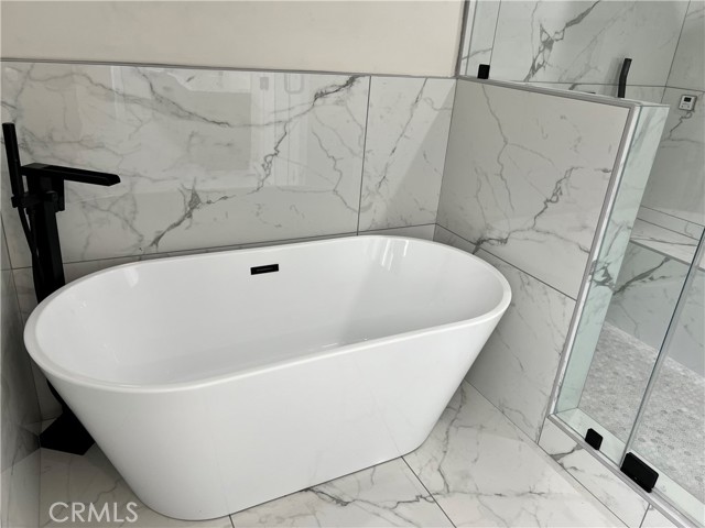 Luxurious soaking tub with modern tub filler