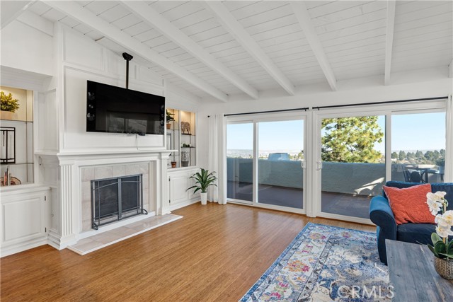 Open and airy living room with huge attached view deck, high ceilings, fireplace, bamboo floors.
