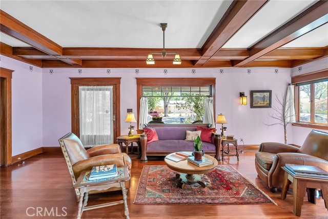 Entry with large window framing the tree lined street outside.