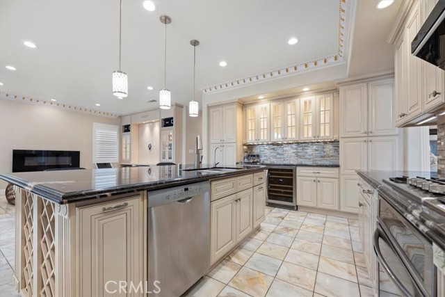 Kitchen with gorgeous granite counter tops, cabinets, center island and onyx flooring.