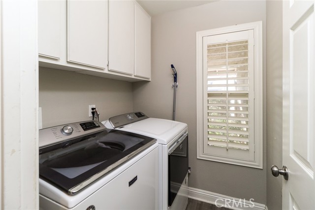 downstairs laundry room with cabinets and window