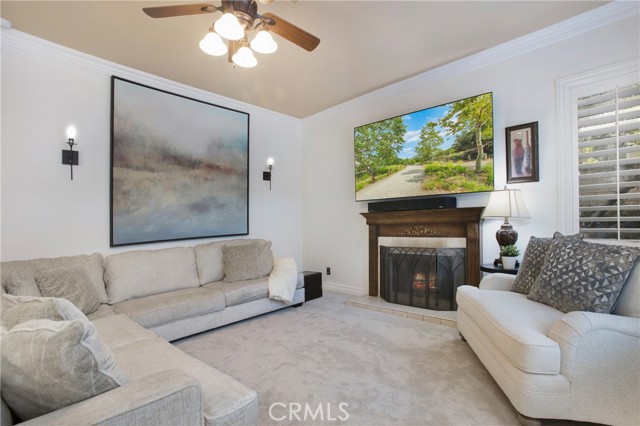 Family room with fireplace and sconces