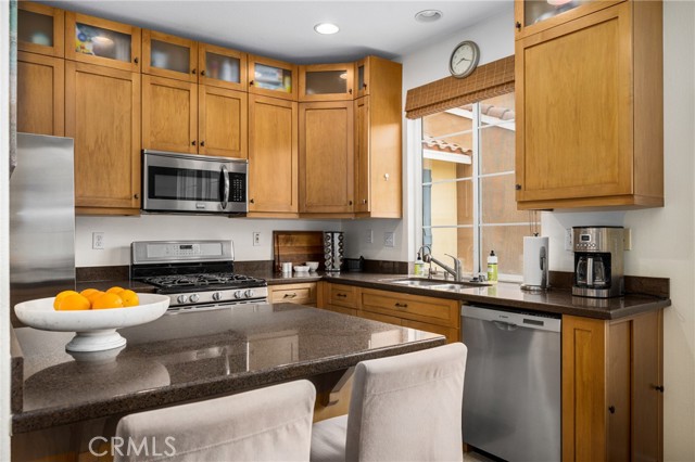 Updated kitchen with custom soft close cabinets with drawer pulls, quartz counters and stainless steel appliances.  Nice island with sit-up bar.