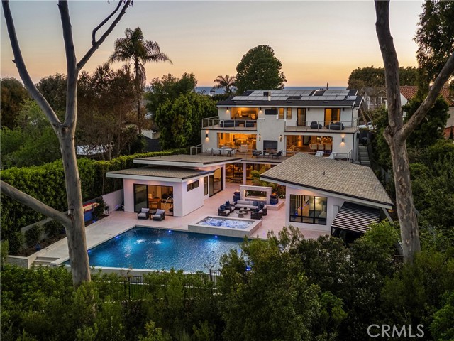 552 Seaward Rd Corona del Mar, California Introducing a 2018-built contemporary masterpiece nestled in the coveted neighborhood of Corona Highlands, right in the heart of Corona del Mar. Wake up to breathtaking sunrises and panoramic views overlooking the iconic Pelican Hill Golf Course.
As you step through the oversized glass pivot door, you're immediately met with a captivating arrival. The main level is designed for seamless indoor-outdoor living, with floor-to-ceiling Fleetwood sliding doors that open to a spectacular pool and spa, fire features, and endless views of the golf course.
The main floor also includes a guest suite with a full bathroom, a striking temperature-controlled glass wine cellar that holds over 600 bottles, and an open-concept living room centered around a sleek double-sided fireplace. The chef’s kitchen is outfitted with stainless steel Thermador appliances, a walk-in pantry, quartz countertops, and opens to a spacious balcony ideal for outdoor dining or lounging.
Upstairs, your private sanctuary awaits. The primary suite offers a cozy fireplace, dual oversized walk-in closets, and a spa-like bath featuring brushed marble floors, a soaking tub, dual vanities, and a stunning all-glass shower. Floor-to-ceiling sliding doors open to a private terrace—perfect for taking in the serenity of nature and the golf course views in complete privacy. Two additional en-suite bedrooms and a spacious laundry room complete the upper level.
Downstairs is an entertainer’s paradise, featuring a custom movie theater with a 120” screen, a game room, and a full bar equipped with beverage fridges, an ice maker, and ample seating. A whole-home surround sound system enhances the ambiance both inside and out.
What truly sets this home apart is the one-of-a-kind, $3M custom-designed backyard. Designed to feel like your own private resort, it boasts a show-stopping pool and spa with fire bowls and water features, lush landscaping, an outdoor kitchen and BBQ, dining space, and two expansive detached ADUs—perfect for guests or multi-generational living. A luxurious steam room completes the experience. In Addition, fully owned solar.
This home feels like a permanent vacation—where every day is elevated by luxury, design, and unforgettable views. With a generous three-car garage, there’s plenty of room for your cars, golf cart, or weekend toys—rounding out the ultimate coastal lifestyle.