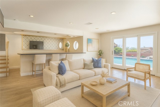 Virtual staging of your family room that leads to your pool and backyard.