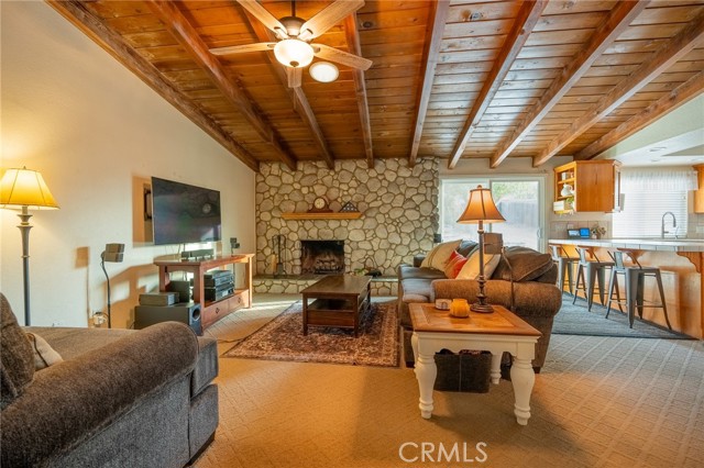 ANOTHER VIEW OF OPEN FLOOR PLAN FAMILY ROOM AND KITCHEN WITH BEAUTIFUL NATURAL WOOD BEAM VAULTED CIELINGS.